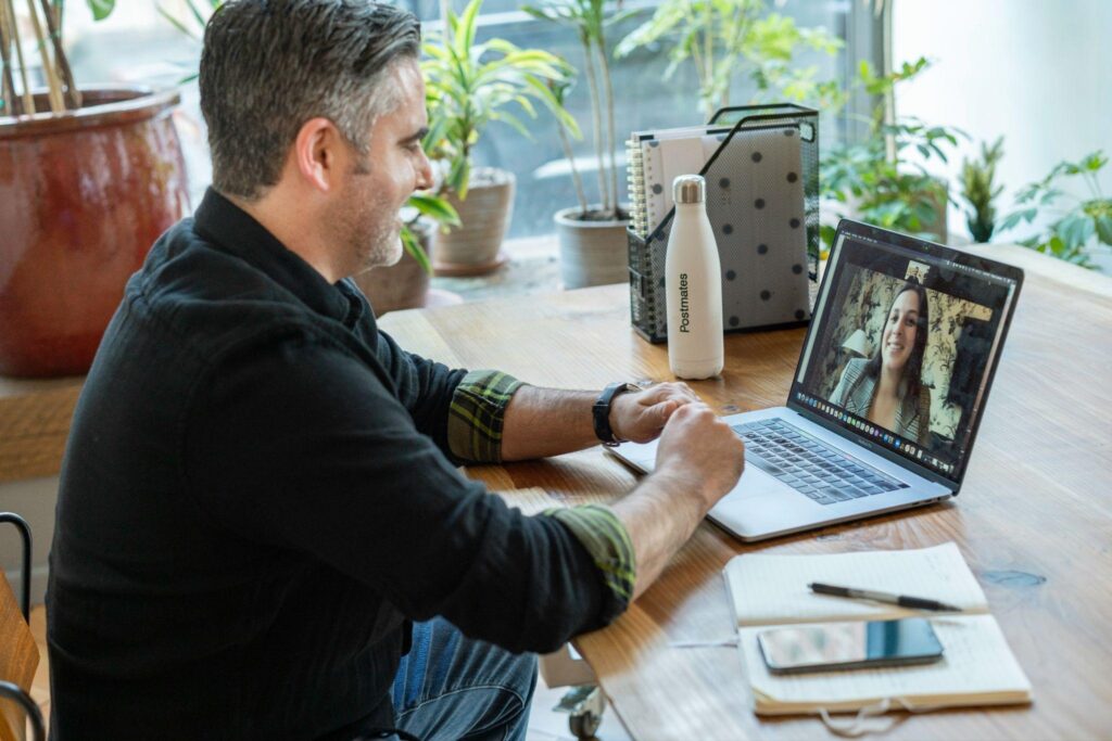 Man working remotely on a video call enabled by cloud-based PBX telephone systems.
