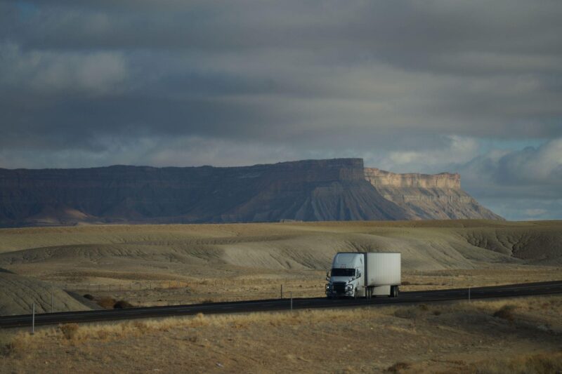 Moving truck traveling a highway, representing Calgary movers supporting long-distance relocations across Alberta.
